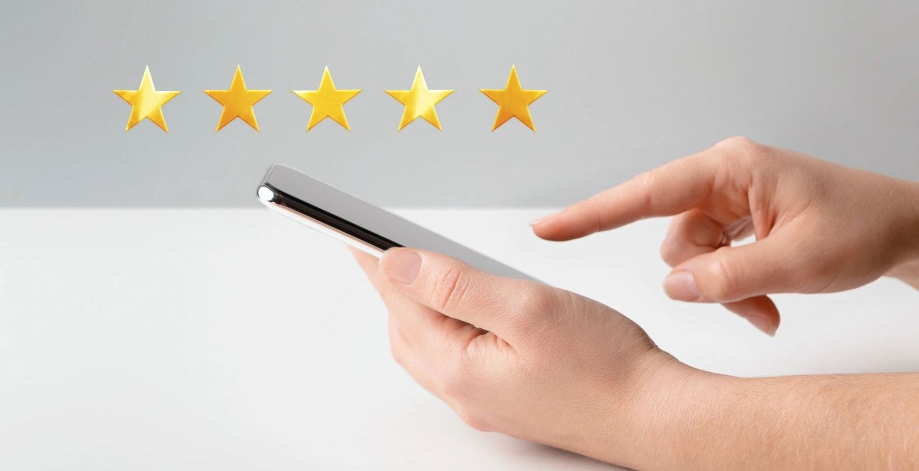 Hand tapping a smartphone with five gold stars above it, suggesting a 5-star rating