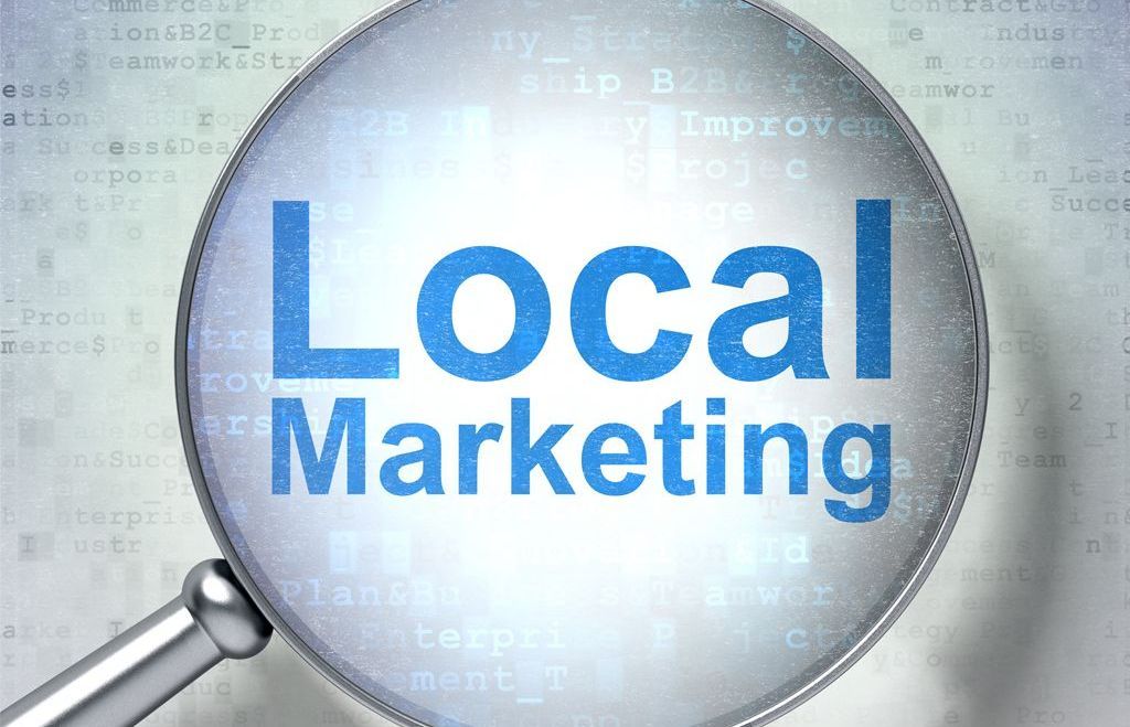 A magnifying glass with the word local marketing on it