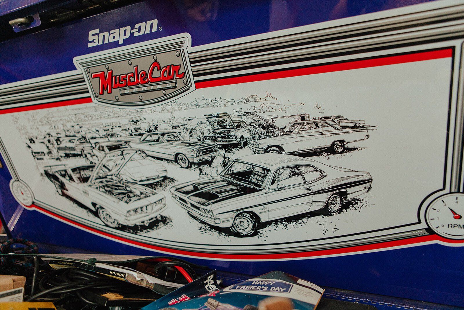 Artwork of classic muscle cars, with Snap-on logo, on a blue and white background.