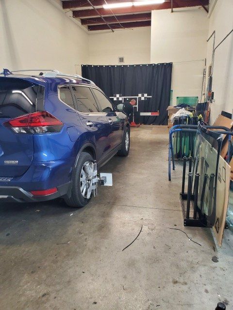 Clamp on The Wheel of Blue Car — Fort Myers, FL — A Plus Auto Glass and Collaborations