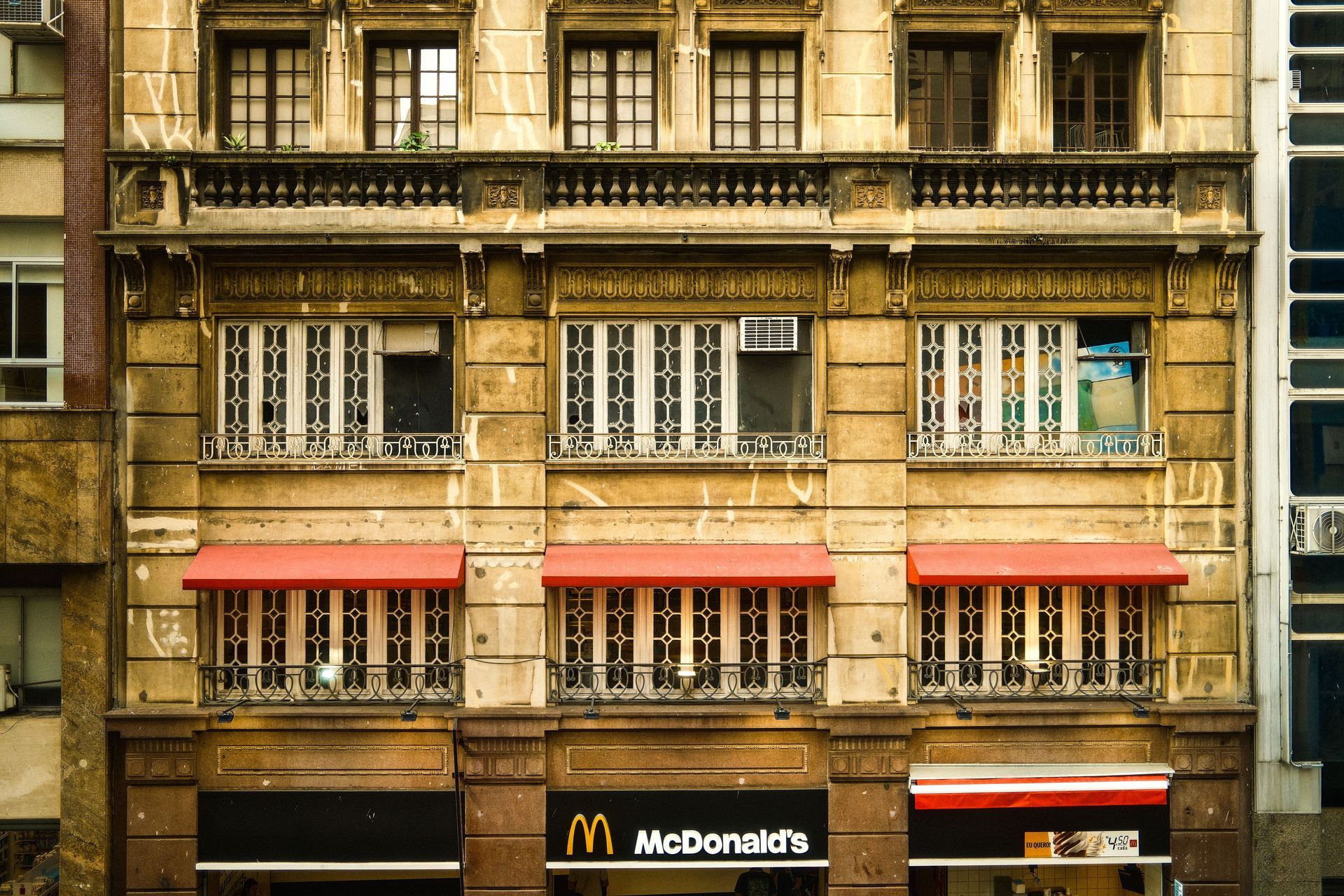 Drone Facade of an old stone building with multiple windows and a McDonald’s storefront at street level