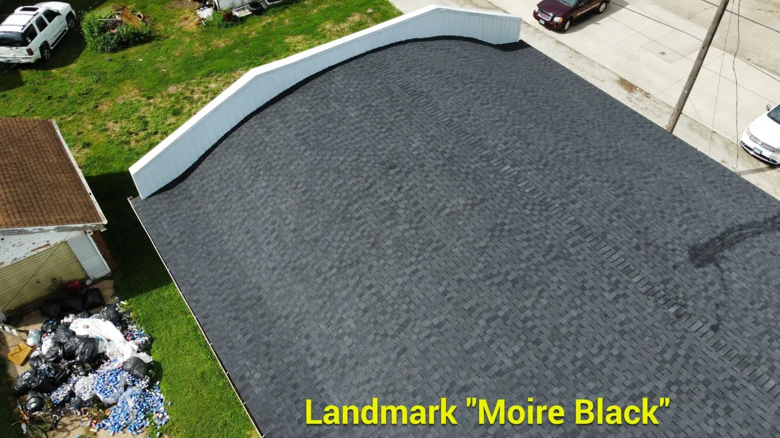 An aerial view of a flat roof covered in dark gray asphalt shingles, labeled Landmark 