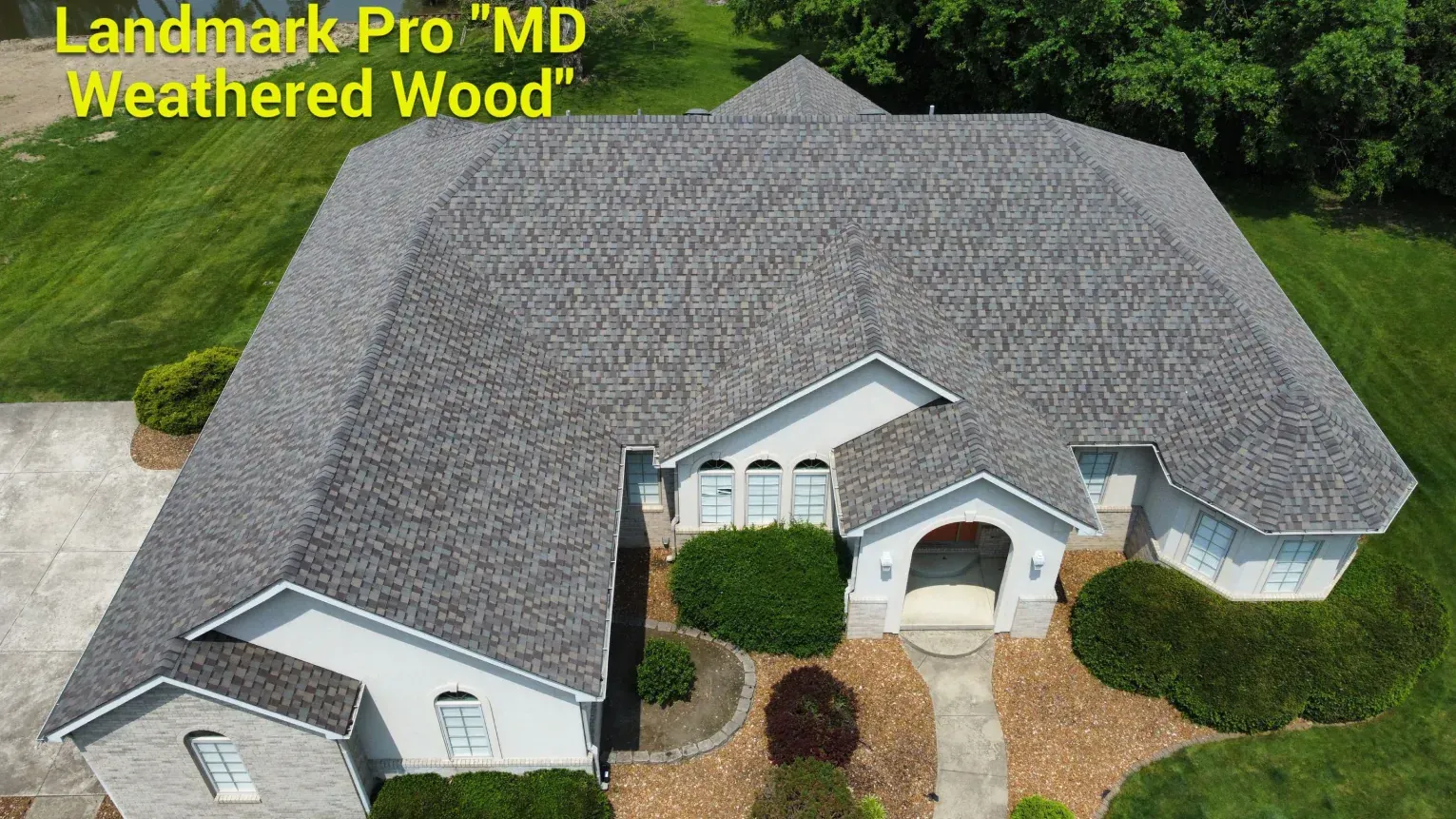 Aerial view of a white home with a grey 