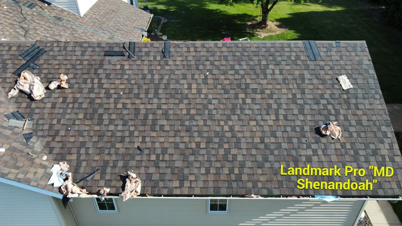 Aerial view of a residential roof under construction with brown 