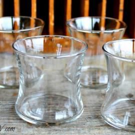 Clear glass tumblers arranged on a wooden table