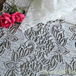 Pink roses on white lace fabric with a floral pattern
