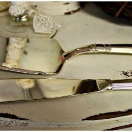 Close-up of a gold and silver watch with a decorative bracelet on a reflective surface