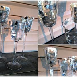 Three silver goblets with clear stems on a dark cloth, shown in close-up from multiple angles