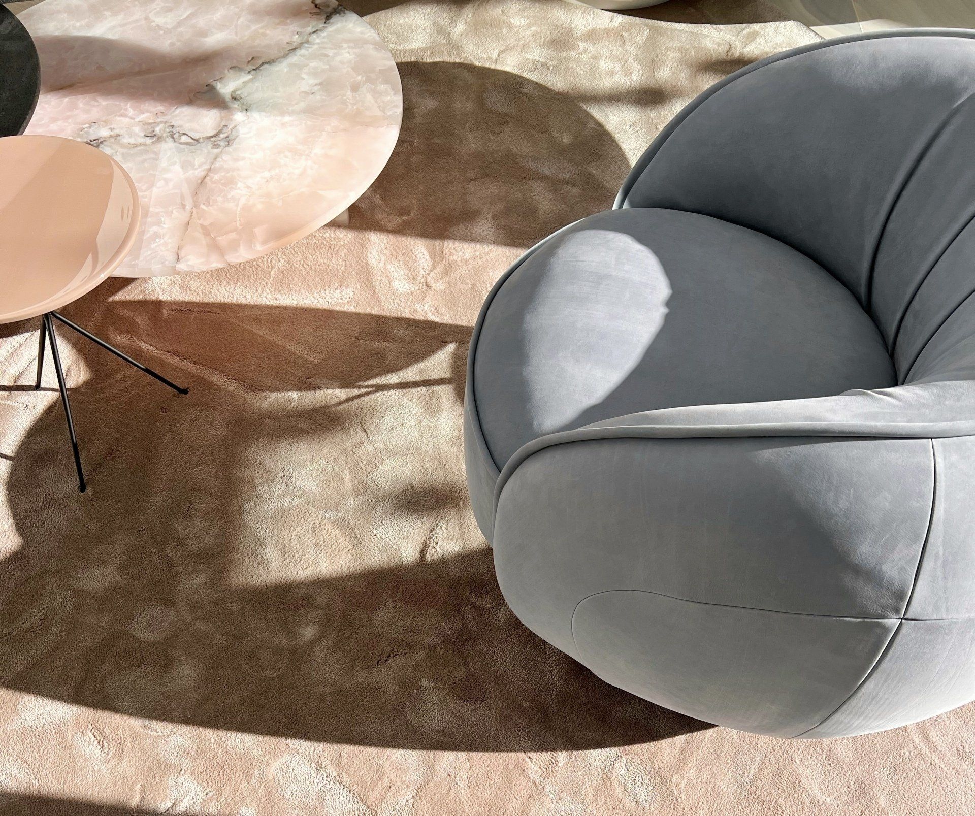 Baxter armchair with marble side tables and layered rug