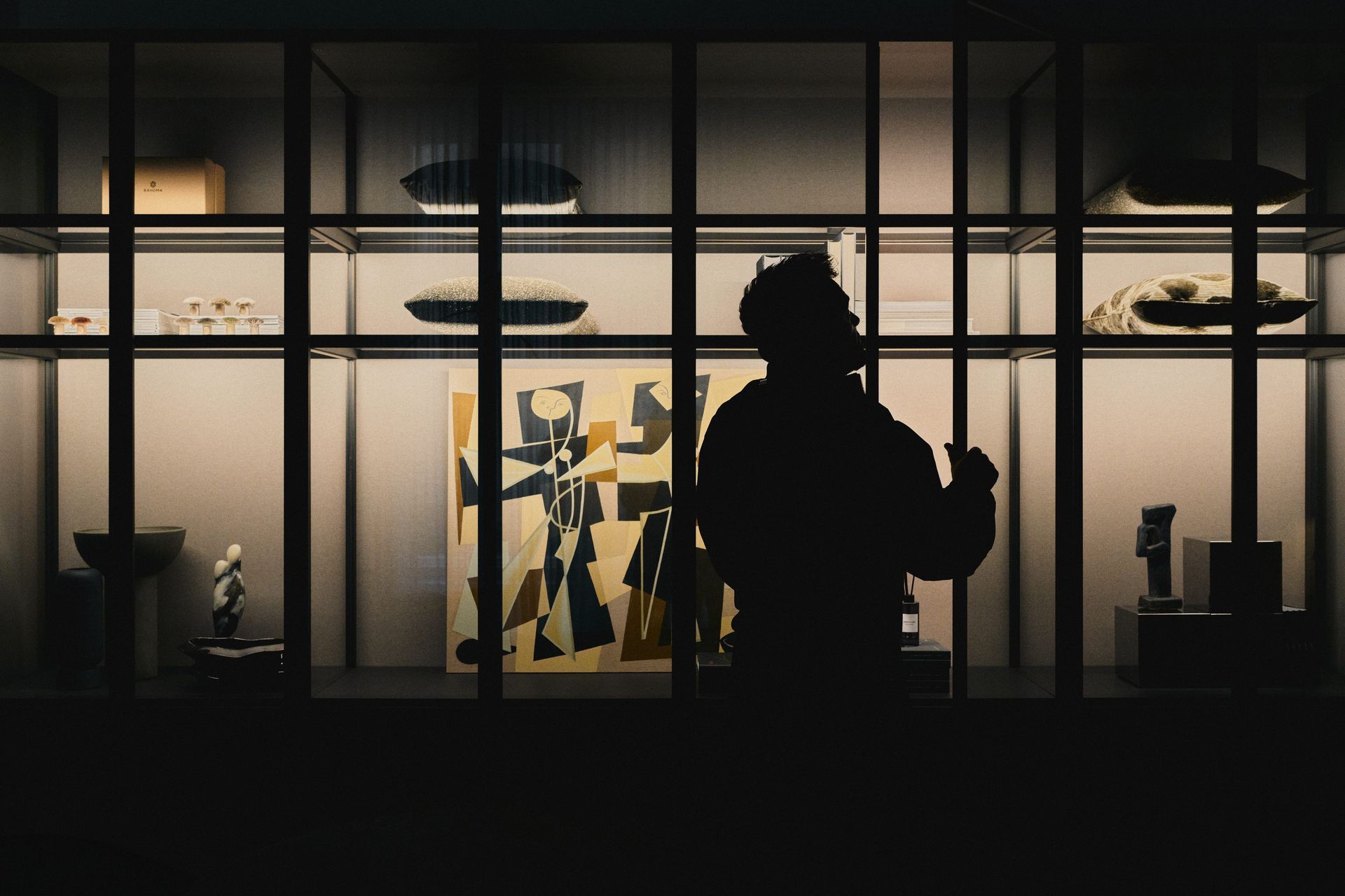 Interior designer viewing artwork inside HRS8, the DÉMARTISTUDIO showroom in Berlin