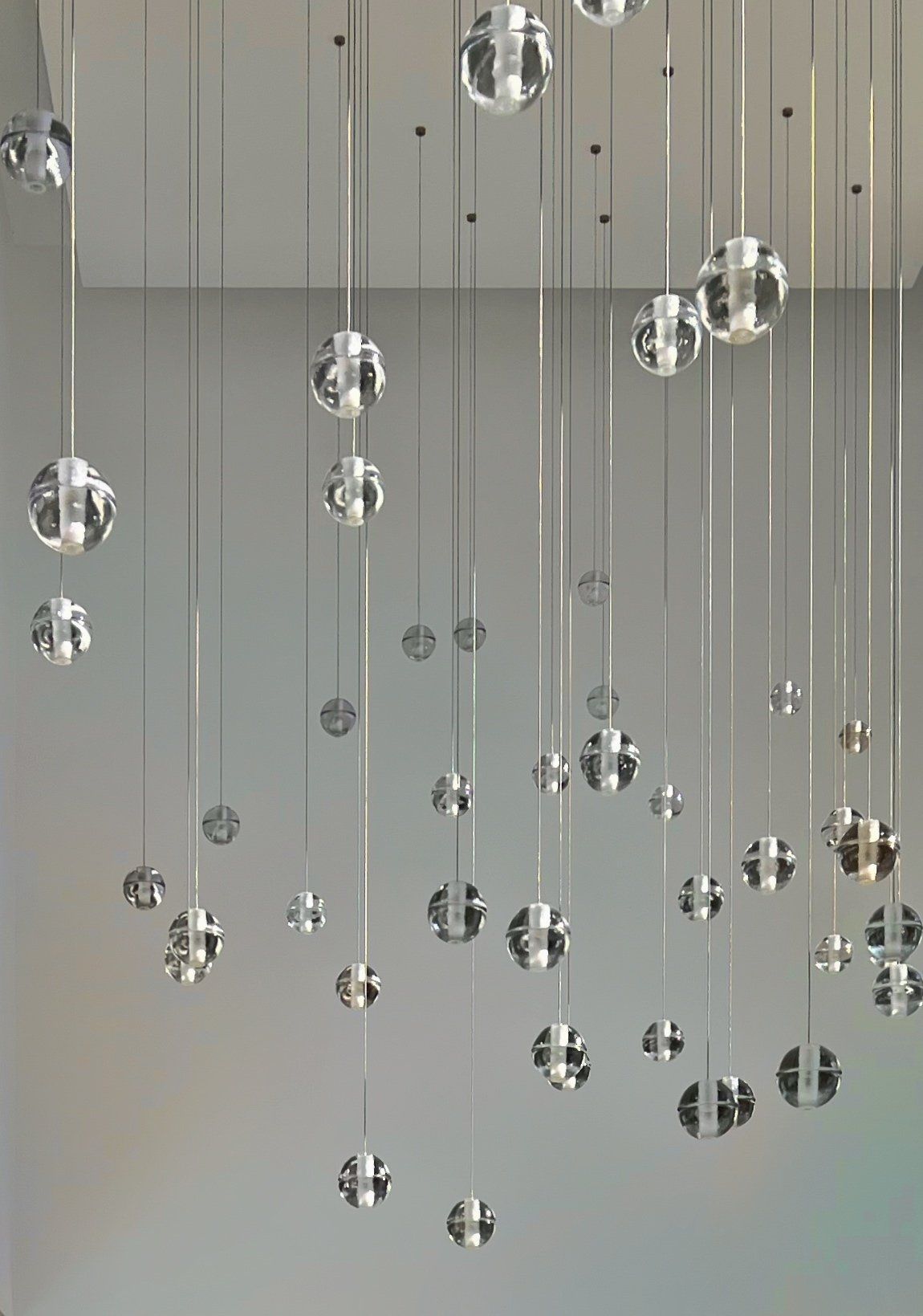 Bocci glass pendant lights suspended in a contemporary luxury interior