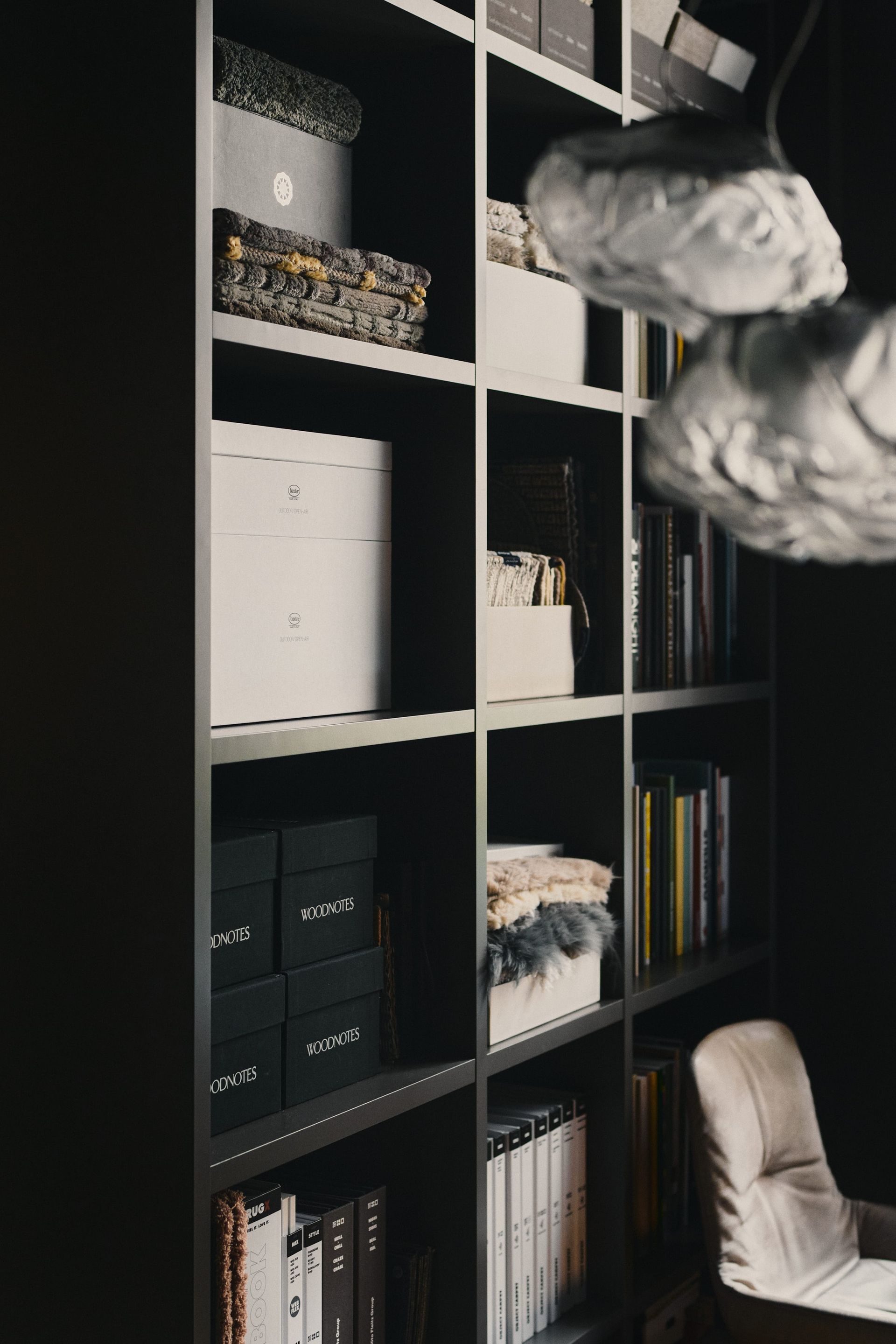 Curated shelving with books, materials and decorative objects at the DÉMARTISTUDIO Berlin showroom