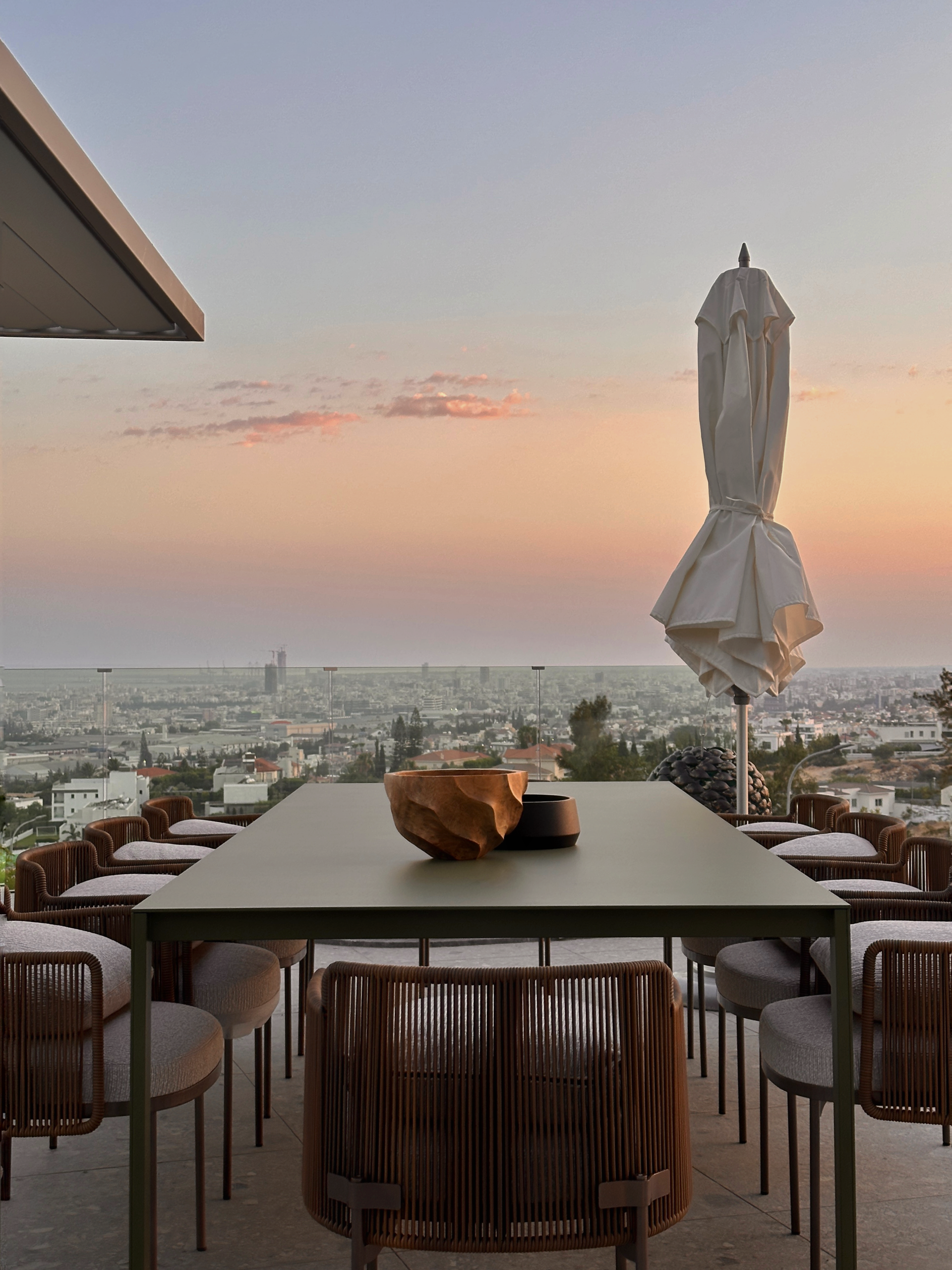 Mediterranean villa terrace with outdoor dining table at sunset