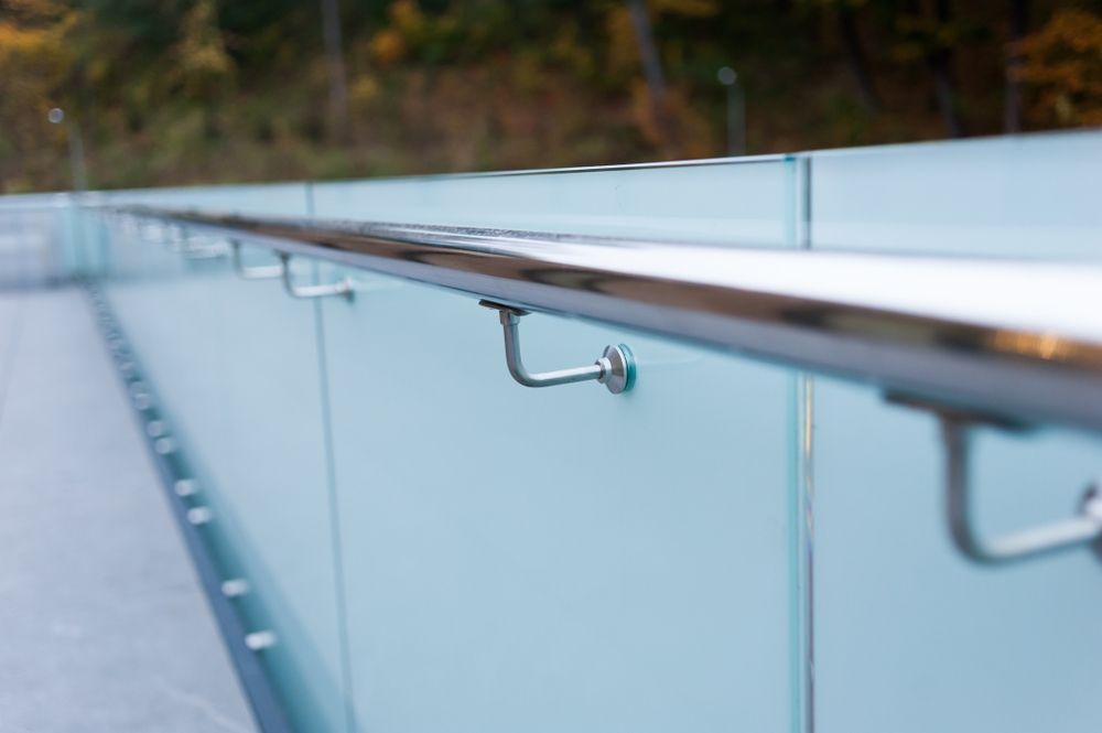 A Close Up Of A Glass Railing On A Bridge — Ballina Best Fencing In Alstonville, NSW