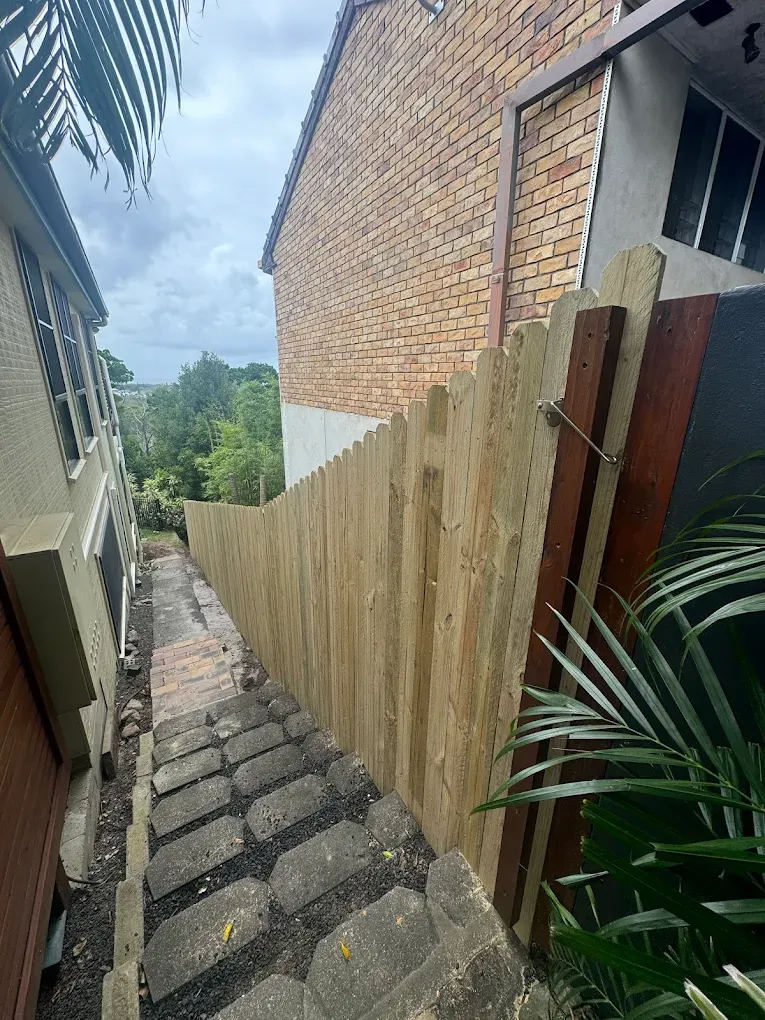 A Wooden Fence Along The Side Of a set of stairs — Ballina Best Fencing In Ballina, NSW