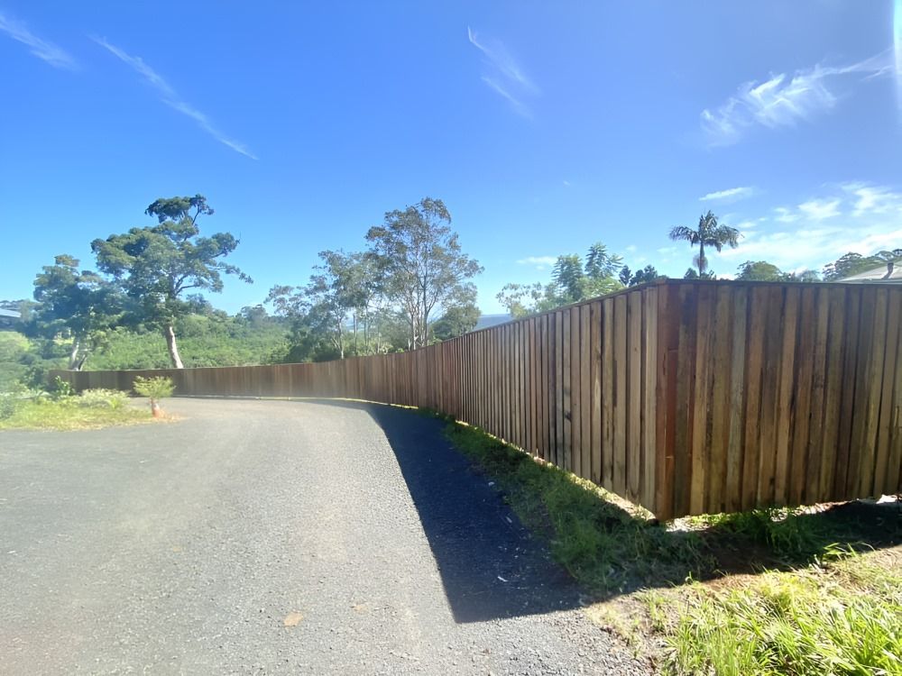 A Wooden Fence Along The Side Of A Road — Ballina Best Fencing In Ballina, NSW