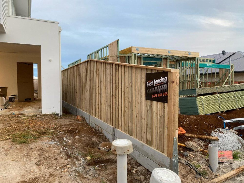 A Wooden Fence Is Surrounding A House Under Construction — Ballina Best Fencing In Northern Rivers, NSW