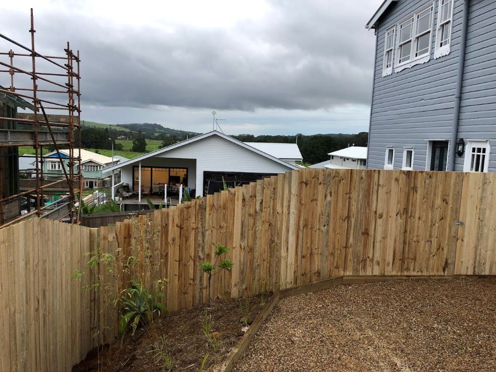 A Wooden Fence Is Surrounding A House Under Construction — Ballina Best Fencing In Ballina, NSW