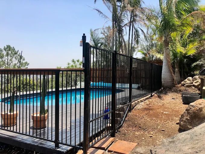 A Balcony With A Table, Chairs, And Glass Railings — Ballina Best Fencing In Ballina, NSW