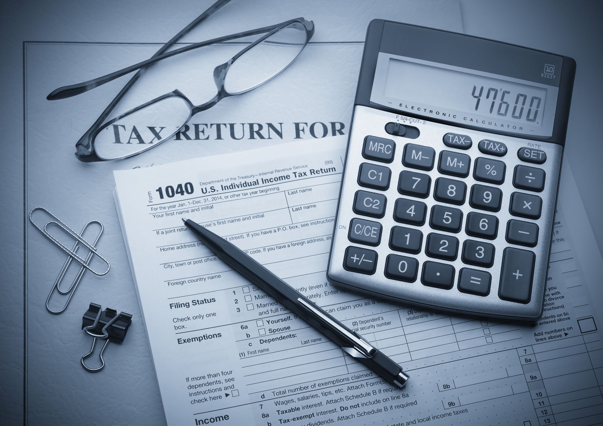 Tax forms, calculator displaying