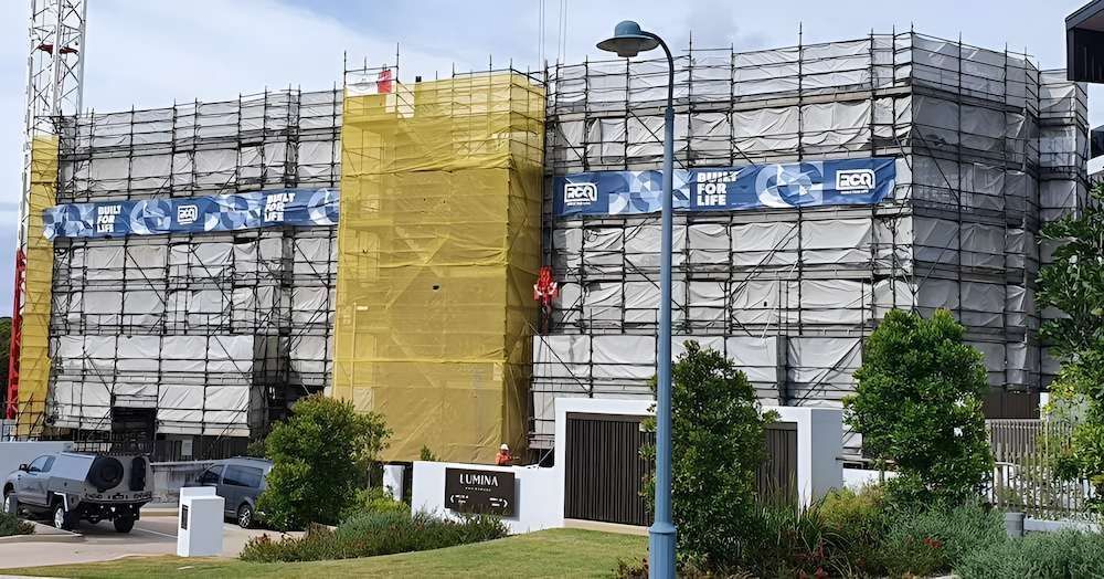 A lArge Building is Being Built With Scaffolding Around It — All Coast Scaffolding In Yandina, QLD