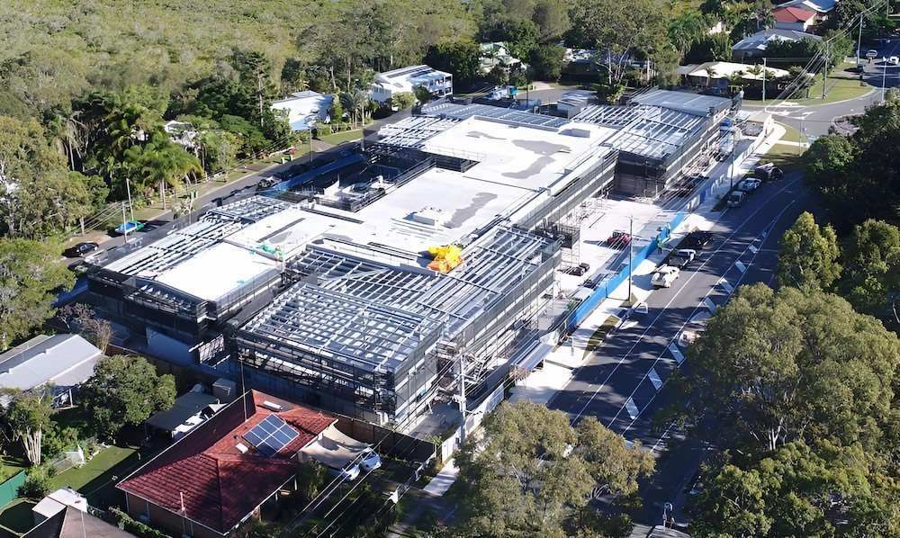An Aerial View of a Large Building Under Construction in a Residential Area — All Coast Scaffolding In Yandina, QLD