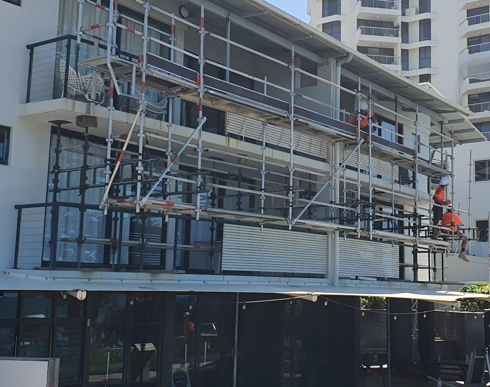 A Building With Scaffolding on the Side of It is Being Remodeled — All Coast Scaffolding In Yandina, QLD