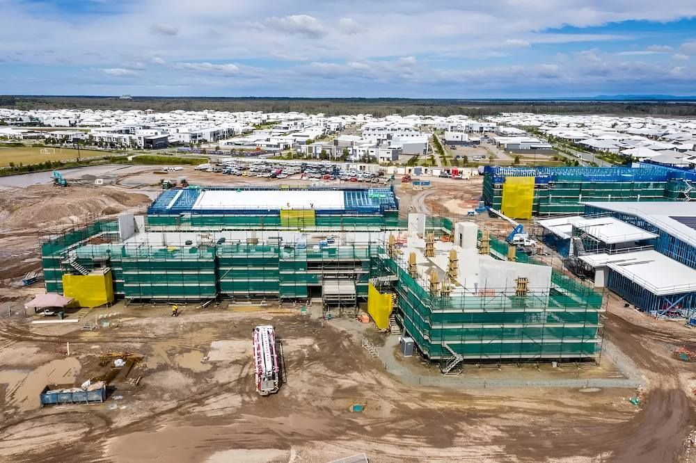 An Aerial View of a Large Building Under Construction in a City — All Coast Scaffolding In Noosa, QLD