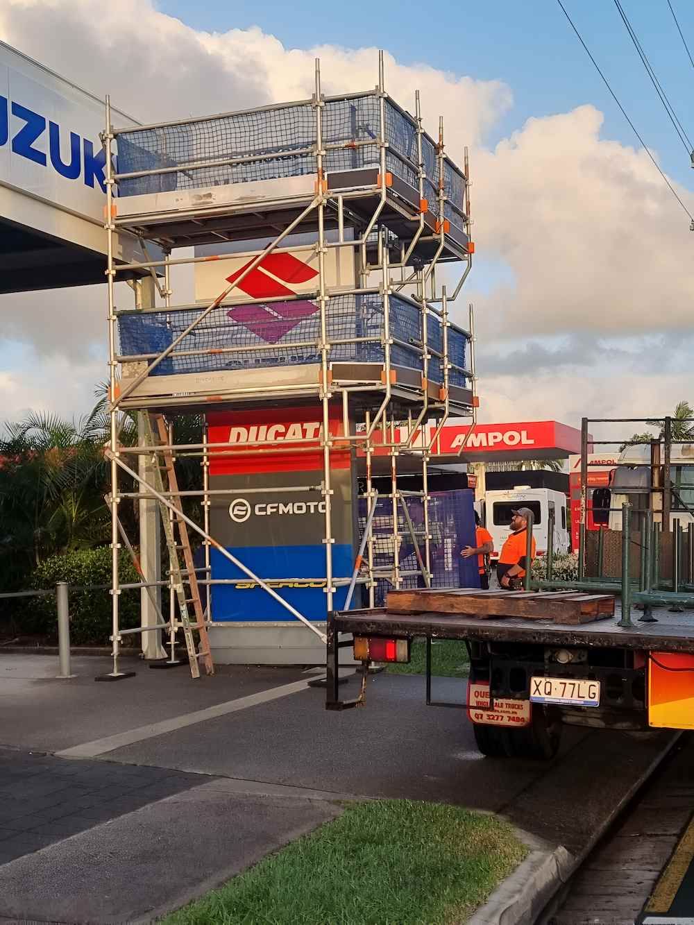 Scaffolding is Being Built in Front of a Building That Says Suzuki — All Coast Scaffolding In Yandina, QLD