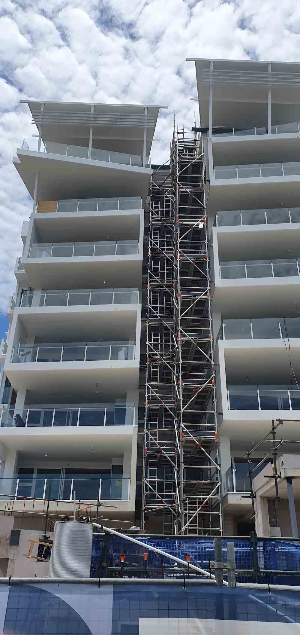 A Large Building Under Construction With Scaffolding Around It — All Coast Scaffolding In Buderim, QLD