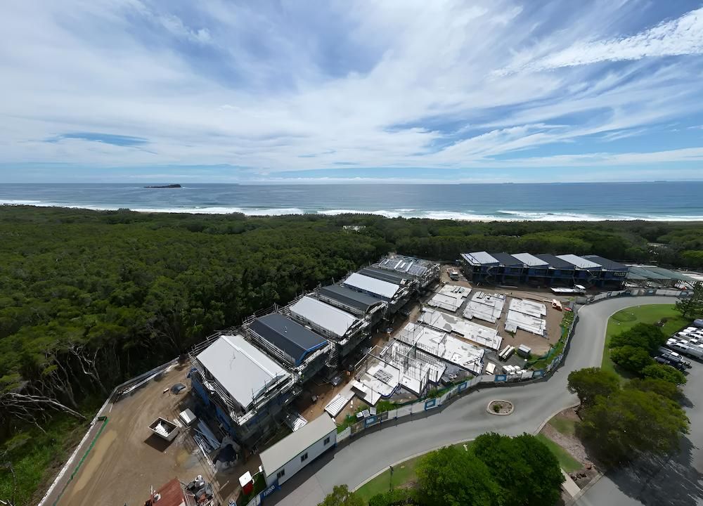 An Aerial View of a Building Under Construction Near the Ocean — All Coast Scaffolding In Yandina, QLD