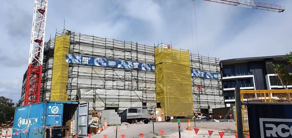 A Large Building is Being Built With Scaffolding and a Crane — All Coast Scaffolding In Yandina, QLD