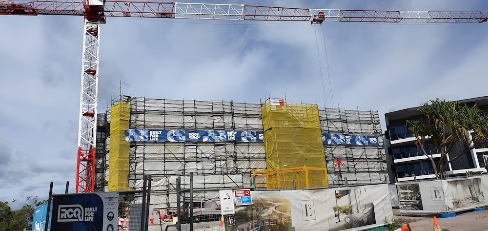 A Large Building is Being Built With Scaffolding and Cranes — All Coast Scaffolding In Yandina, QLD