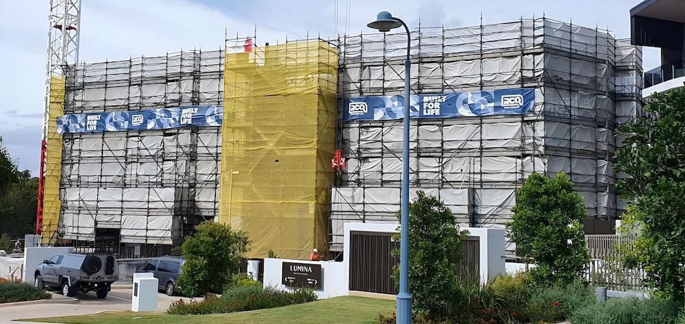 A Large Building is Being Built With Scaffolding Around It — All Coast Scaffolding In Yandina, QLD