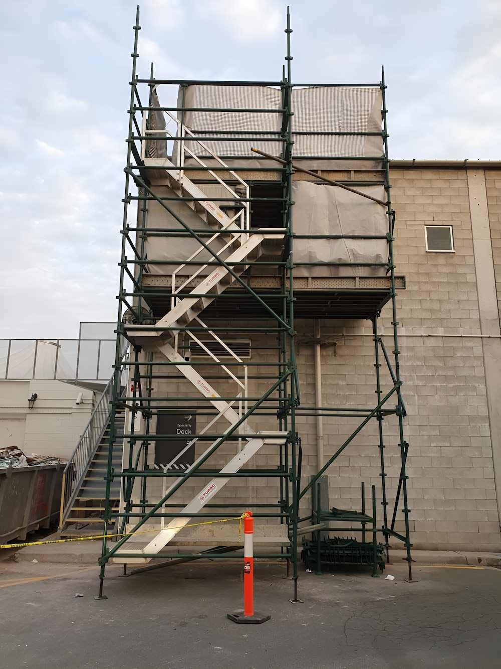 A Scaffolding With Stairs Attached to It is in Front of a Building — All Coast Scaffolding In Mountain Creek, QLD