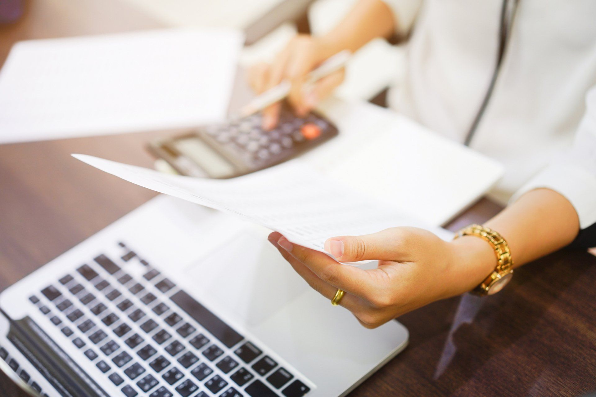 Woman Holding a Statement Report and Press on Calculator — Newcastle, NSW — Neil C Hocquard