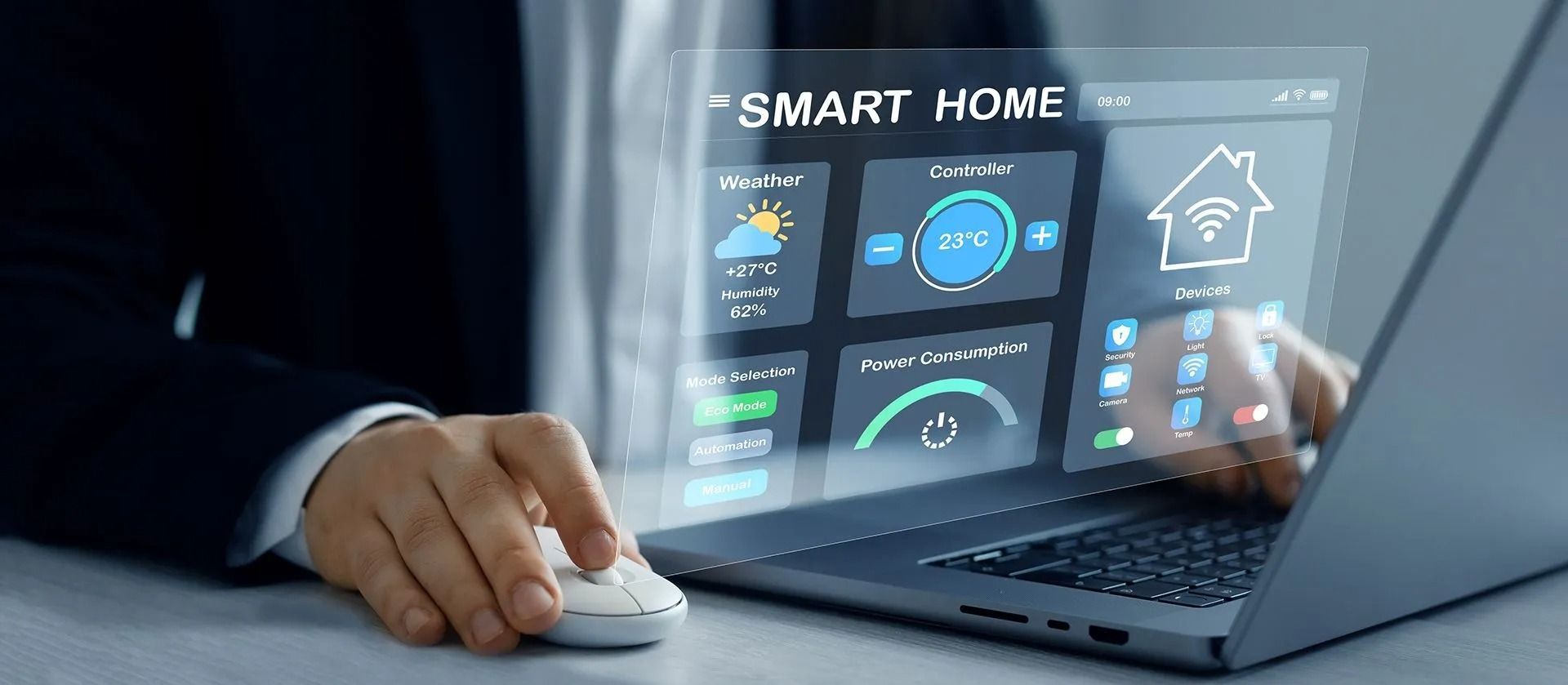 Person using a laptop with a smart home control dashboard and mouse on a desk