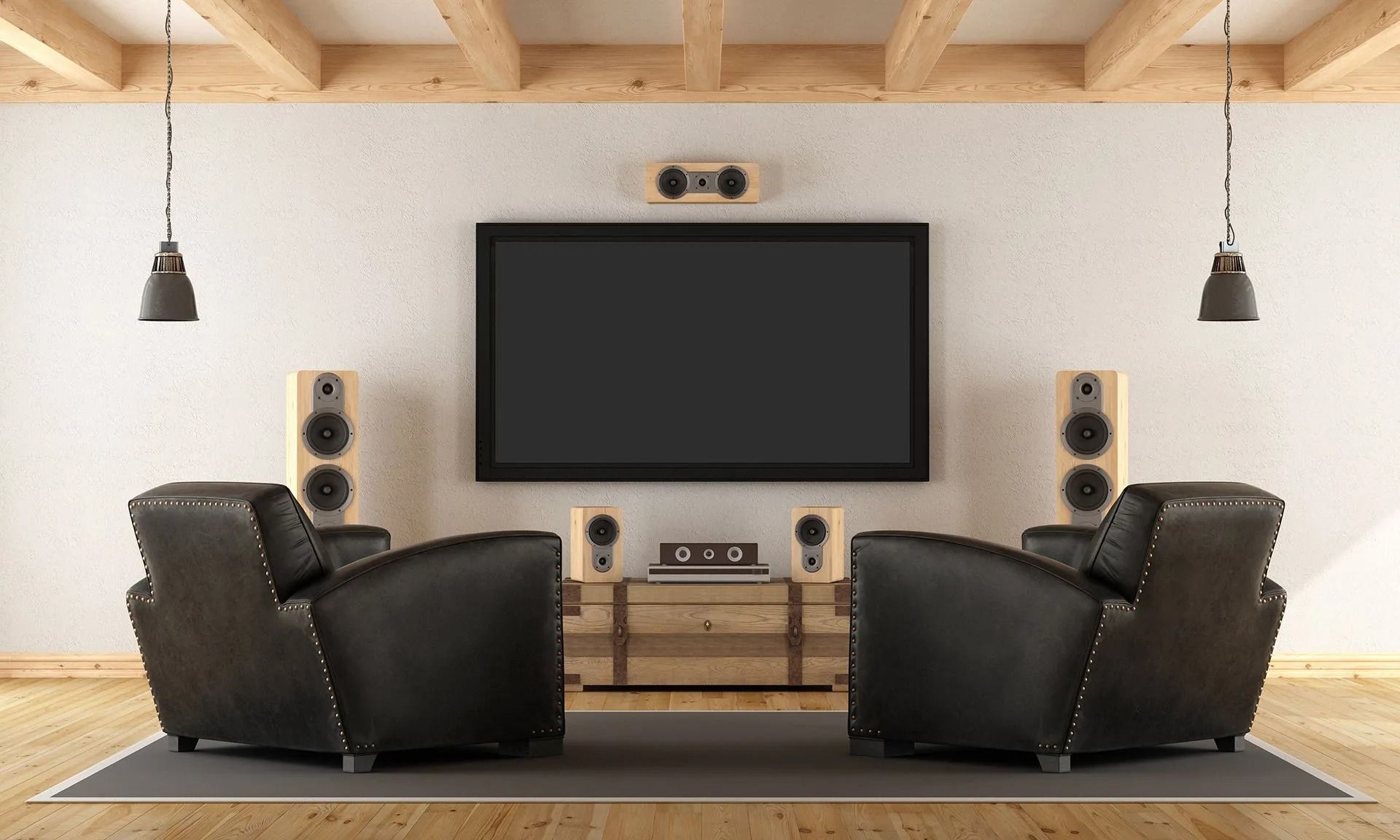 Modern home theater with large TV, surround speakers, and two black recliners on a rug