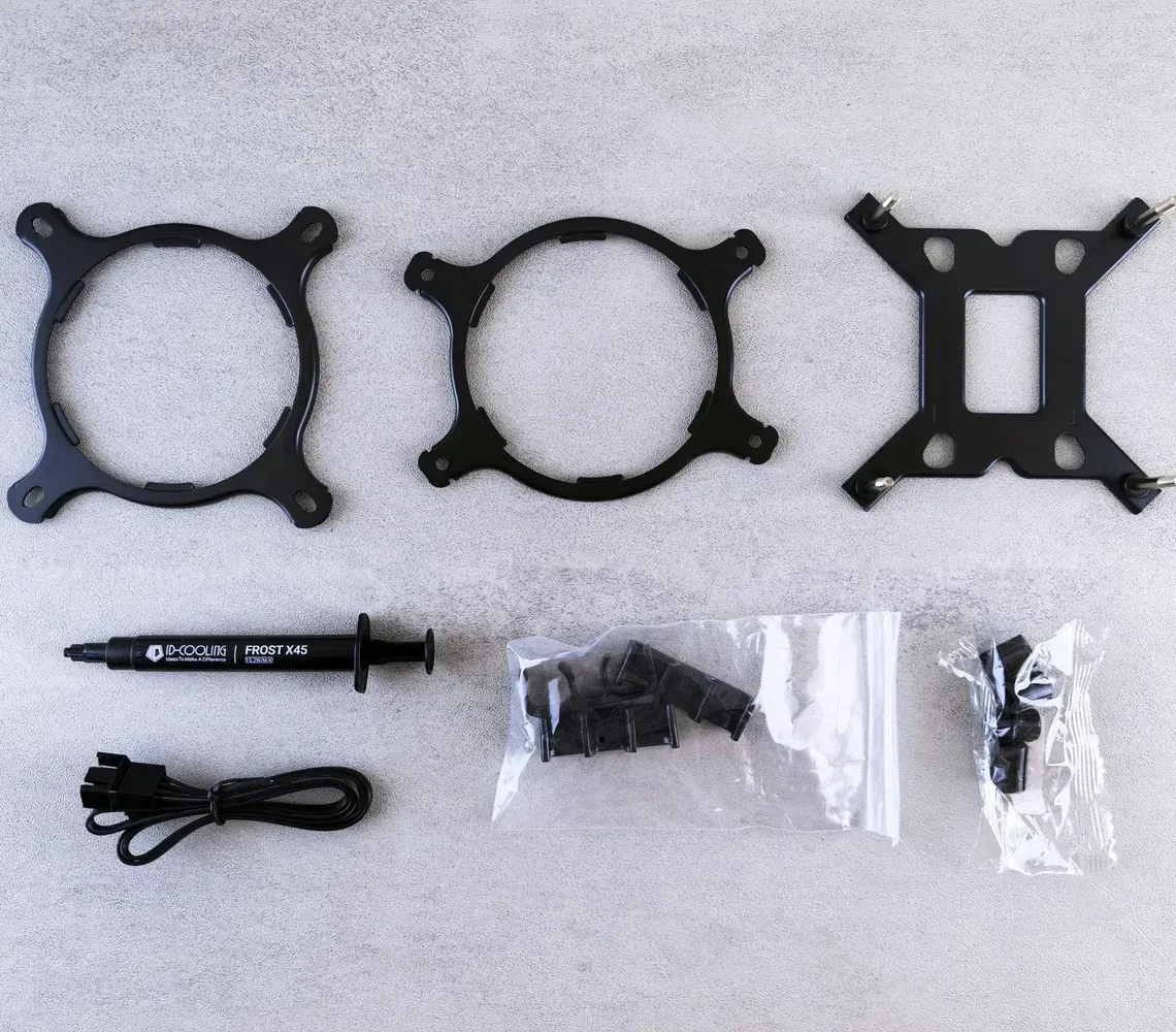 Black mounting bracket set with screwdriver, cable, screws, and zip ties on a white background
