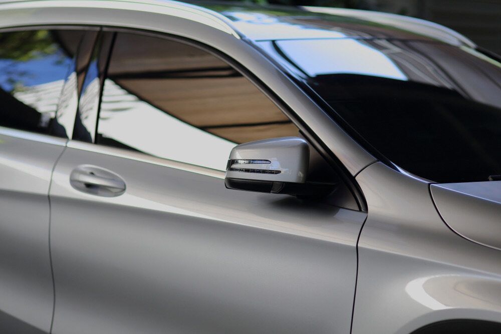 A Dark Grey car has tinted windows — Rod's Total Tint In Beresford, NSW