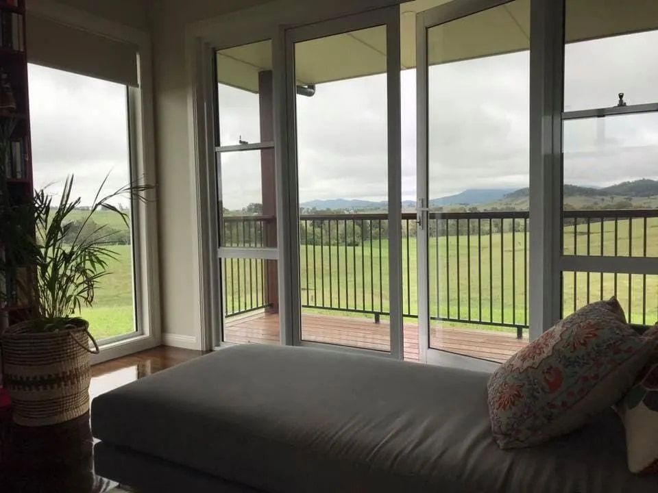 A lounge with window looking out at backyard — Rod's Total Tint In Maitland, NSW