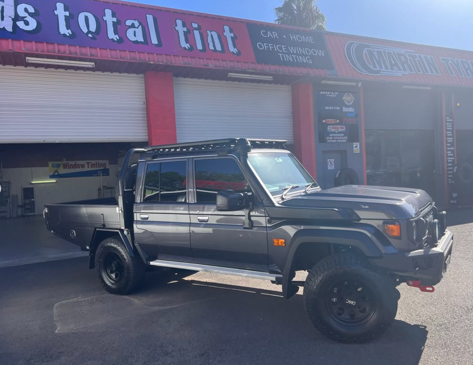 A Ute is parked outside workshop with tinted windows — Rod's Total Tint In Beresford, NSW