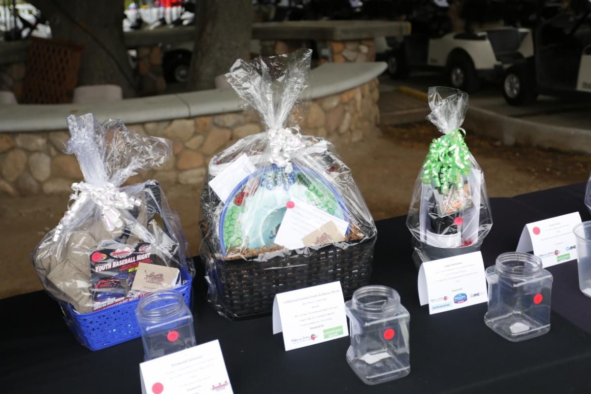 Three baskets are sitting on a table with a golf cart in the background.