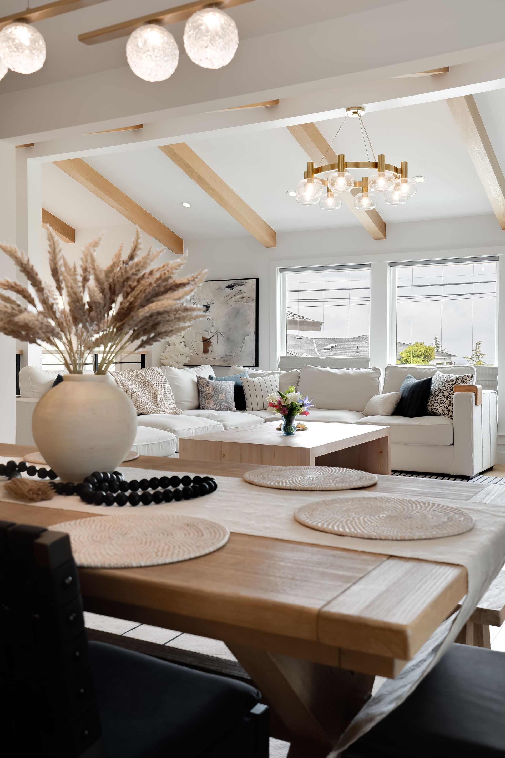 Dining room with a table set for a meal, and a white couch in the background.