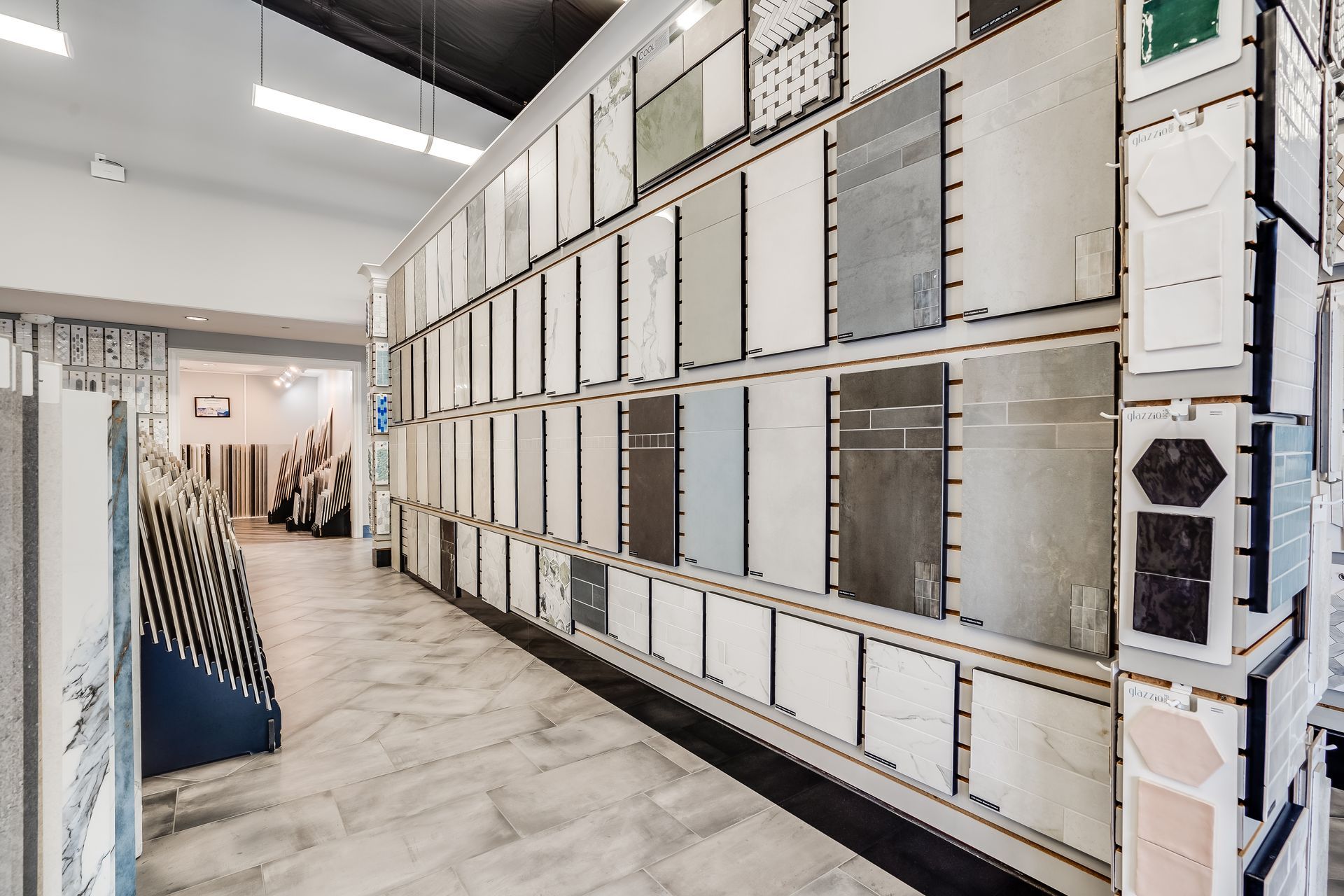 Modern gallery hallway with white framed wall panels and marble flooring