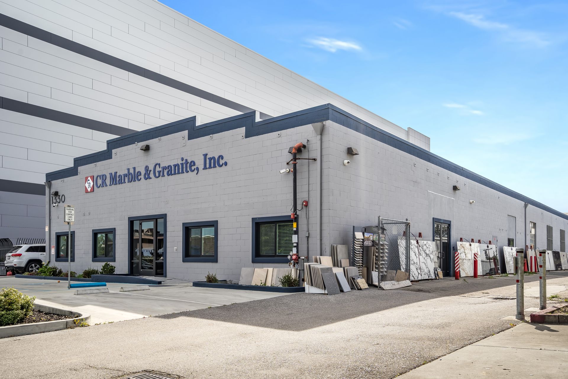 Exterior of a granite and marble business warehouse with stone slabs displayed outside