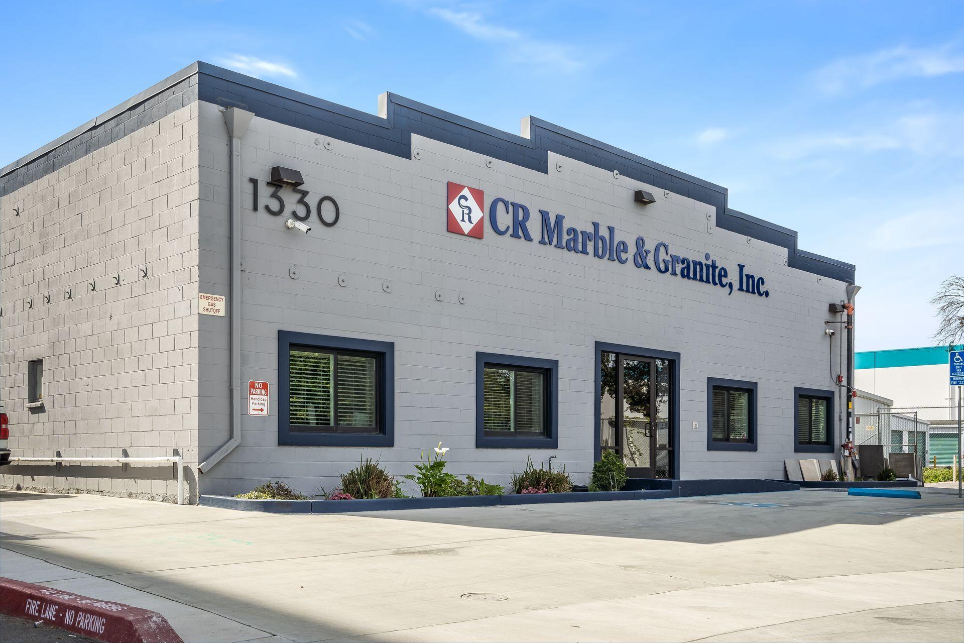 Exterior of CR Marble & Granite, Inc. storefront at 1330, with gray facade and large windows
