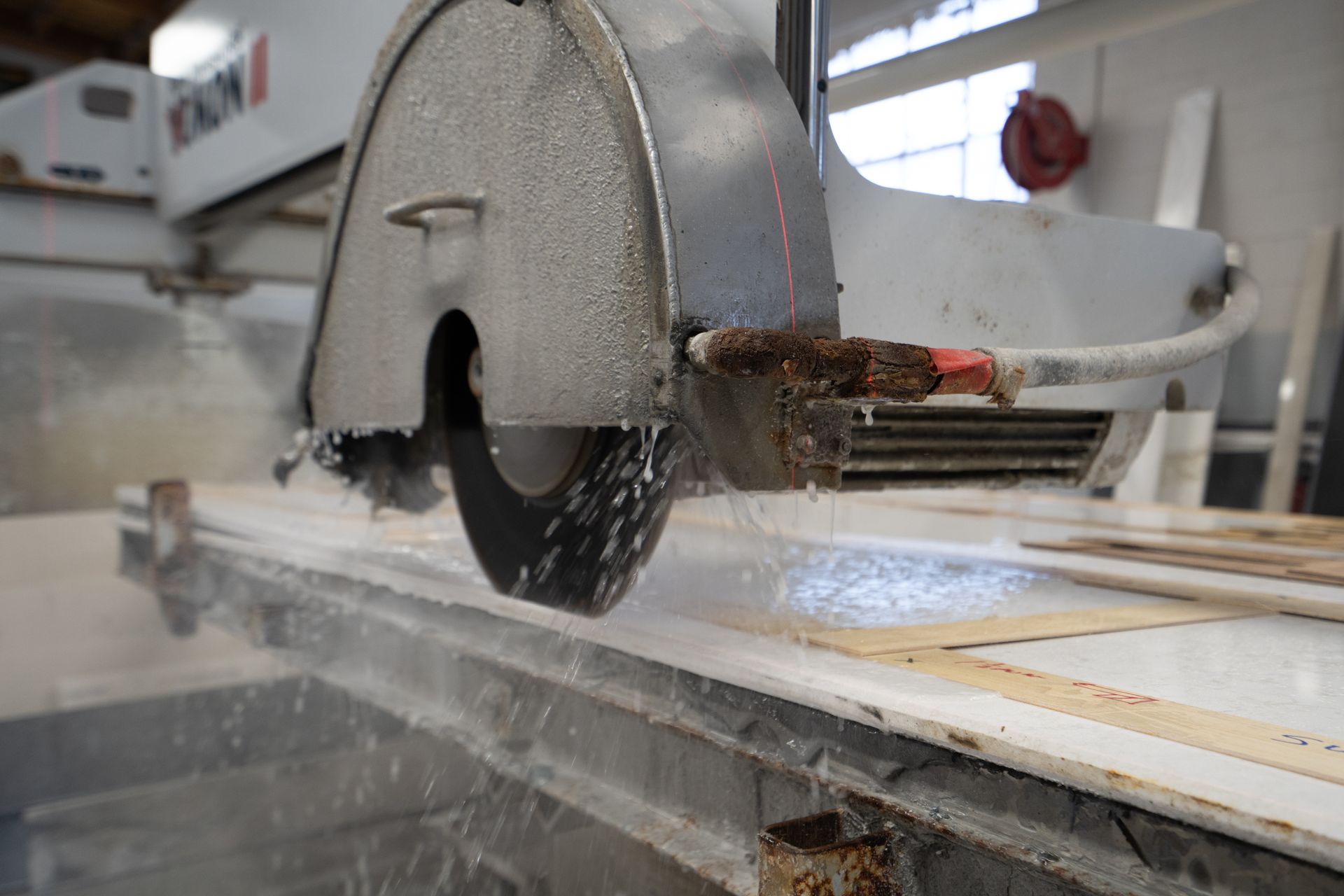 Circular saw cutting wood on a table saw with sawdust flying