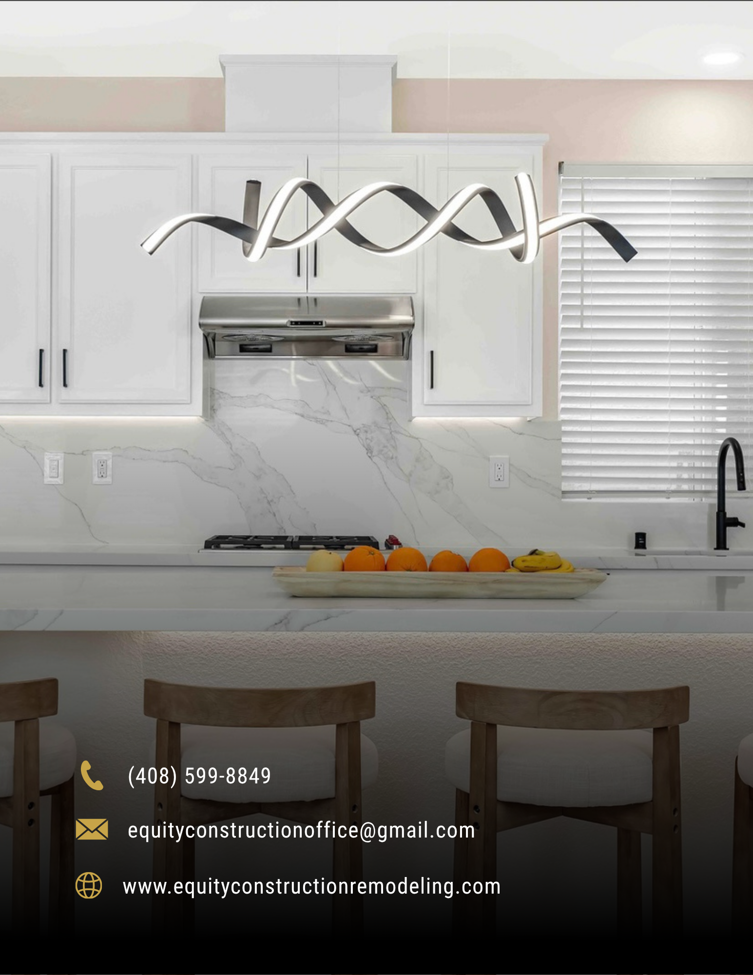 Modern white kitchen with marble island, chrome pendant light, and fruit bowl on the counter