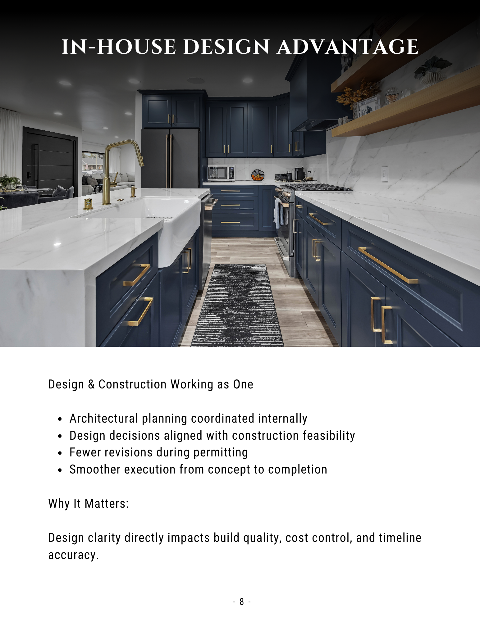 Modern navy-and-white kitchen with marble island and brass accents, titled